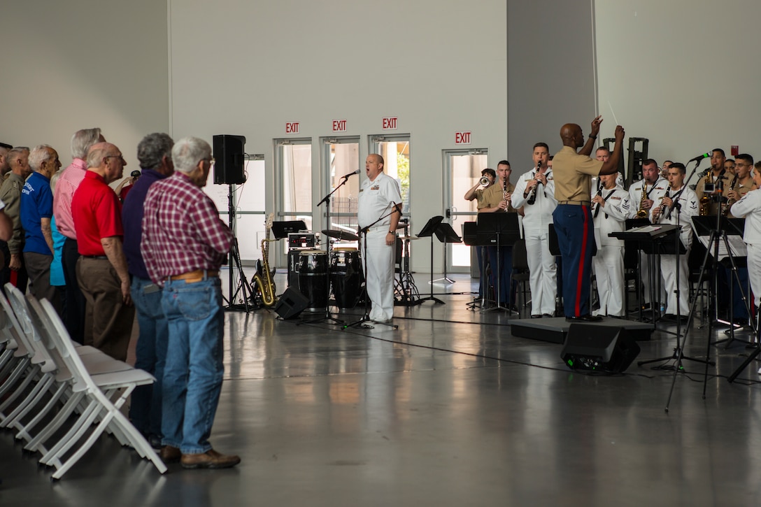 Chief Warrant Officer 2 DeMarius Jackson (left), officer in charge of Marine Corps Band New Orleans, conducts the Marines with Marine Corps Band New Orleans and the sailors from Navy Band Southeast out of Jacksonville, Florida, in their final performs at the World War II Museum for Navy week in New Orleans, April 21, 2018. The celebration is an opportunity for citizens of New Orleans and surrounding areas to meet service members and witness the latest capabilities of today’s maritime service. (U.S. Marine Corps photo by Lance Cpl. Melany Vasquez/Released)