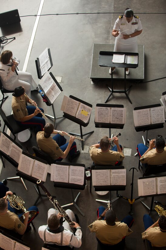 Luslaida Barbosa (left), director of Navy Band Southeast, conducts the Marines with Marine Corps Band New Orleans and the sailors from Navy Band Southeast out of Jacksonville, Florida, perform at the World War II Museum for Navy week in New Orleans, April 21, 2018.