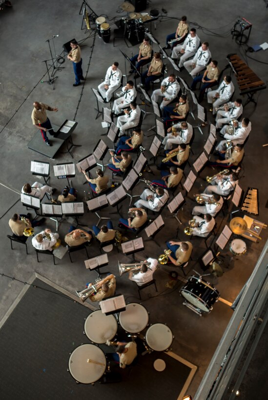 Chief Warrant Officer 2 DeMarius Jackson (left), officer in charge of Marine Corps Band New Orleans, conducts the Marines with Marine Corps Band New Orleans and the sailors from Navy Band Southeast out of Jacksonville, Florida, perform at the World War II Museum for Navy week in New Orleans, April 21, 2018.