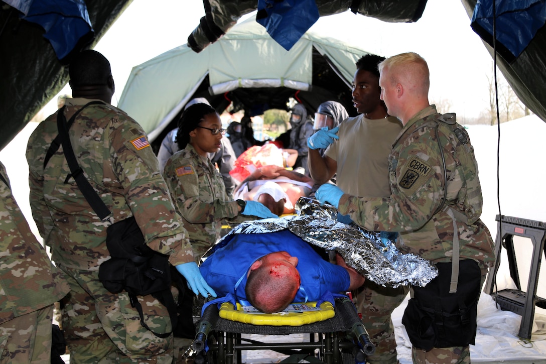 Soldiers provide medical aid to mock patients.