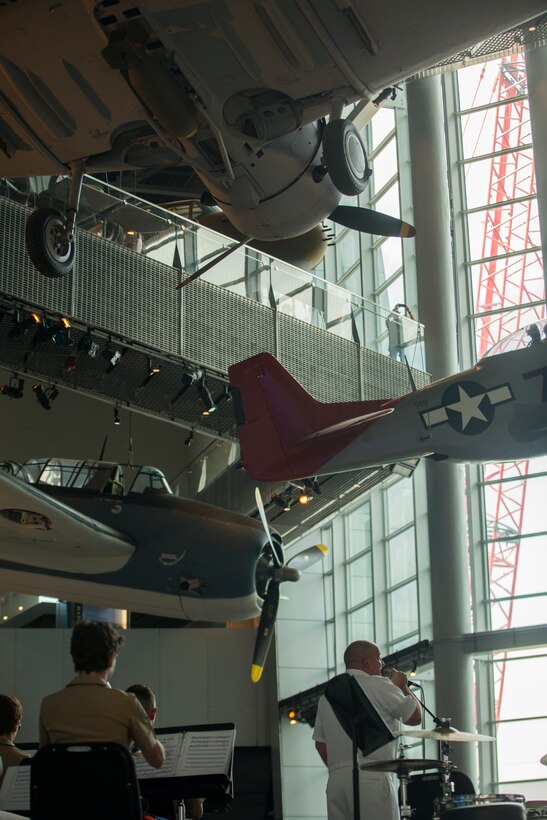 Thomas Horner, a performer with of Navy Band Southeast, sings with the accompany of the Marine Corps Band New Orleans and Navy Band Southeast out of Jacksonville, Florida, at the World War II Museum for Navy week in New Orleans, April 21, 2018.