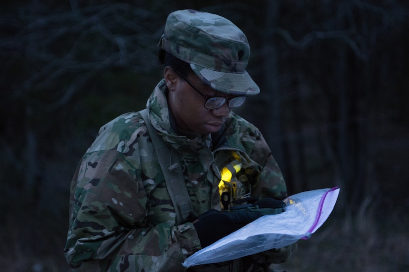 Spc. Alexis Colvin, with the 13th Battalion, 108th Ordnance Regiment, 3rd Brigade, 94th Training Division, plans her strategy for night land navigation as part of the 80th Training Command's 2018 Best Warrior Competition at Fort Knox, Kentucky, April 14, 2018. (U.S. Army Reserve photo by Maj. Addie Leonhardt, 80th Training Command)