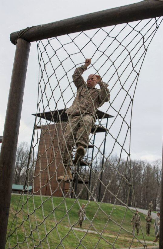 Sgt. 1st Class Eric Ojeda, from the 94th Training Division, maneuvers through a rope climb in the obstacle course portion of the 80th Training Command's 2018 Best Warrior Competition at Fort Knox, Kentucky, April 14, 2018. (U.S. Army Reserve photo by Maj. Addie Leonhardt, 80th Training Command)
