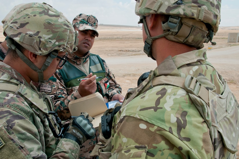 Jordanian Sgt. Hamza Auoda Smith discusses a tricky mathematical problem that forward observers ran into with his U.S. counterparts during an exercise at Jordan’s Joint Training Center near Amman, Jordan, April 11, 2018. The problem originated in a measurement discrepancy between tools that was quickly identified and corrected. The bilateral training was part of the Jordan Operational Engagement Program and focused on the exchange of infantry tactics and techniques.