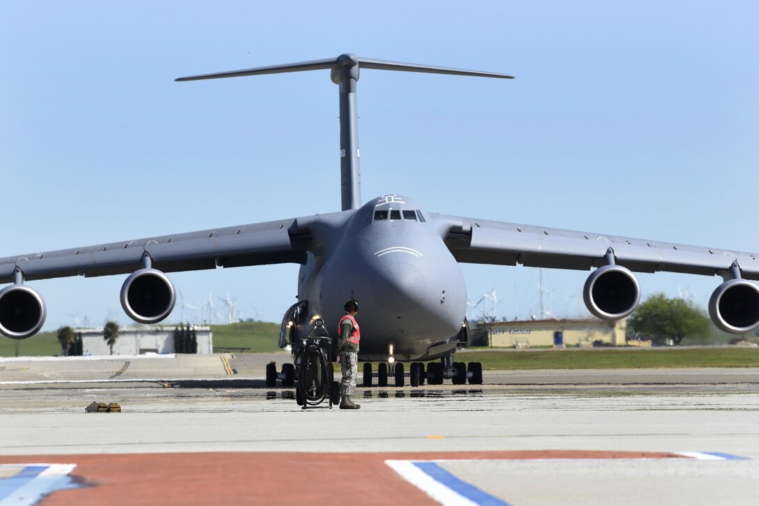 An airman prepares to service the last C-5M Super Galaxy to join the fleet.