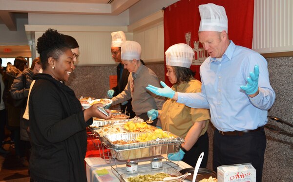 Matthew Ludwig, Chief, Engineering Division, shares a light moment with Andree Pierre of Human Resources at the serving table during Diversity Day, April 3, 2018.