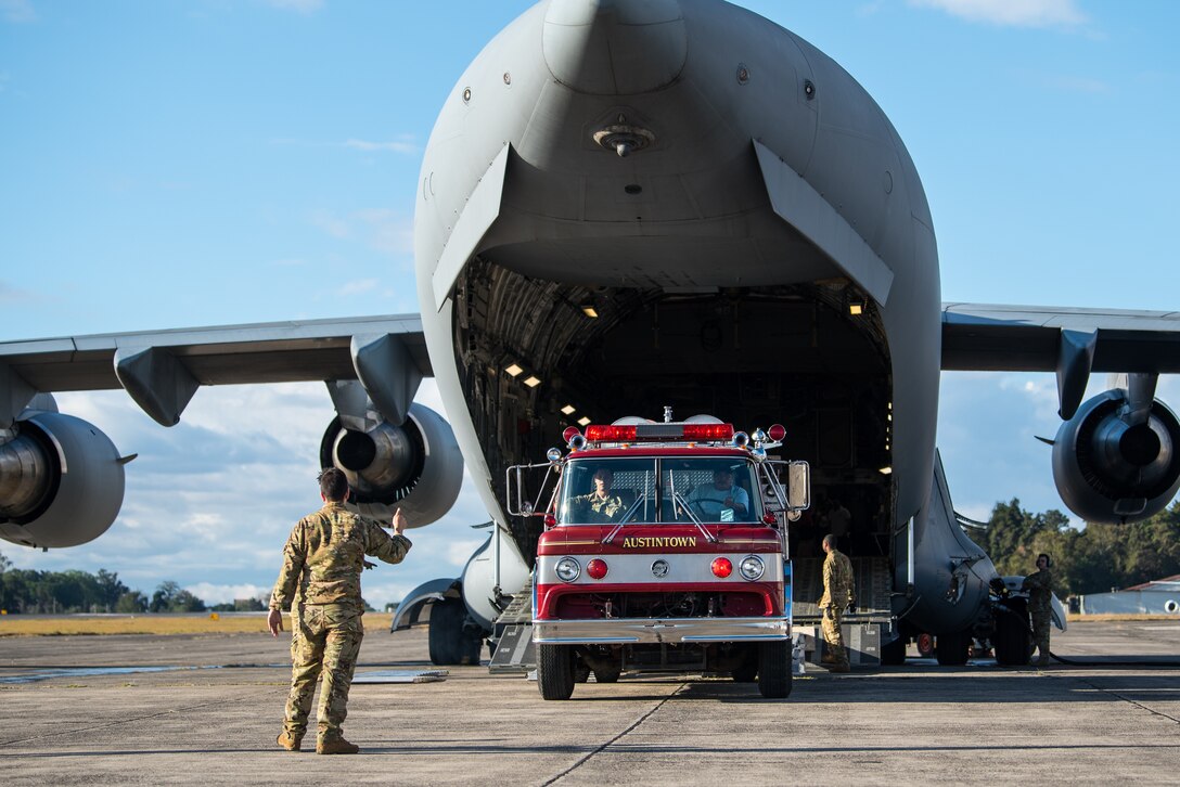 A firetruck is offloaded from an U.S. Air Force cargo plane.