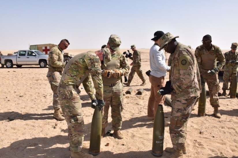 Combat Engineers with the 35th Engineer Brigade, Missouri National Guard pack C4 into 155mm rounds. The explosives were used in a training event with the 797th Explosive Ordnance Disposal (EOD) Company of Fort Hood, Texas.