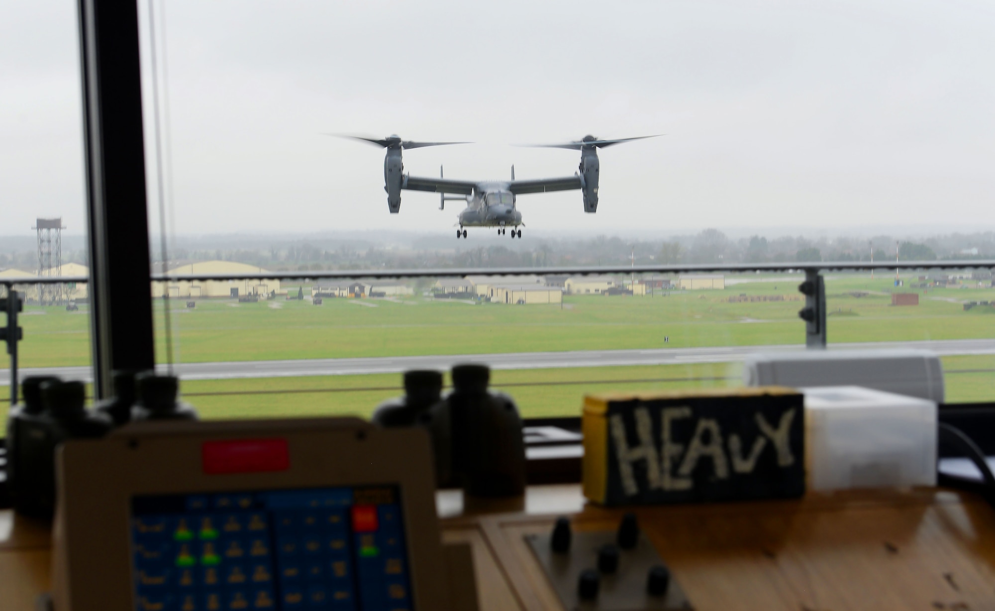 A U.S. Air Force CV-22 Osprey assigned to 352d Special Operations Wing passes the air traffic control tower during landing at RAF Mildenhall, England, April 9, 2018. The ever-watching eye of the air traffic controllers from the 100th Operations Support Squadron keeps our skies and aircraft safe. (U.S. Air Force photo by Airman 1st Class Alexandria Lee)