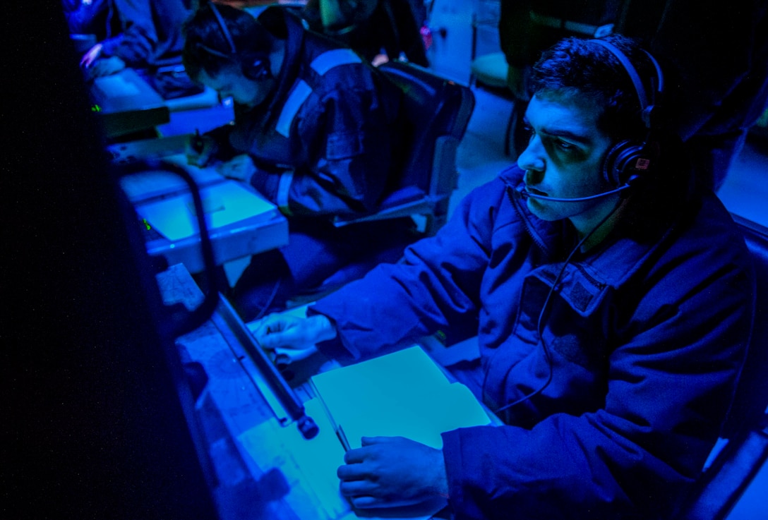 A U.S. Navy Sonar Technician monitors sonar equipment.