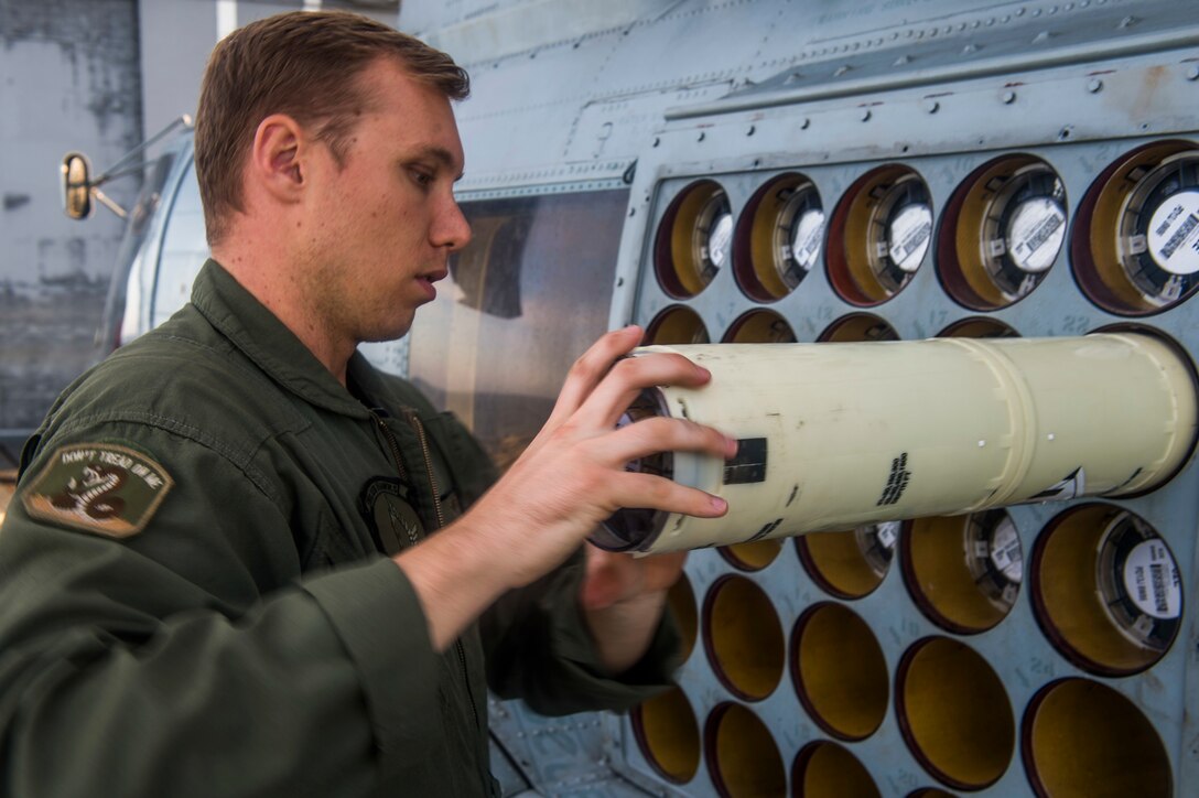 A U.S. Navy Sailor loads sonobuoys onto an MH-60R Sea Hawk helicopter.