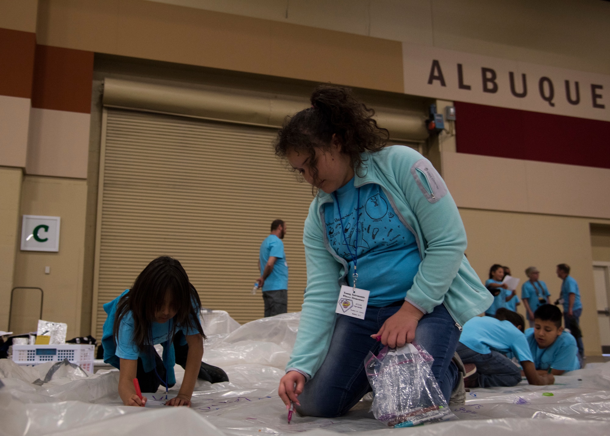 Students from local Albuquerque schools participate in Air Force Research Lab's Mission to Mars at the Albuquerque Convention Center in Albuquerque, N.M., April 20. The Mars Missions flight provides fifth grade students an opportunity to plan and carry out a simulated manned mission to Mars, their objective is to build a colony of habitats that can sustain life.