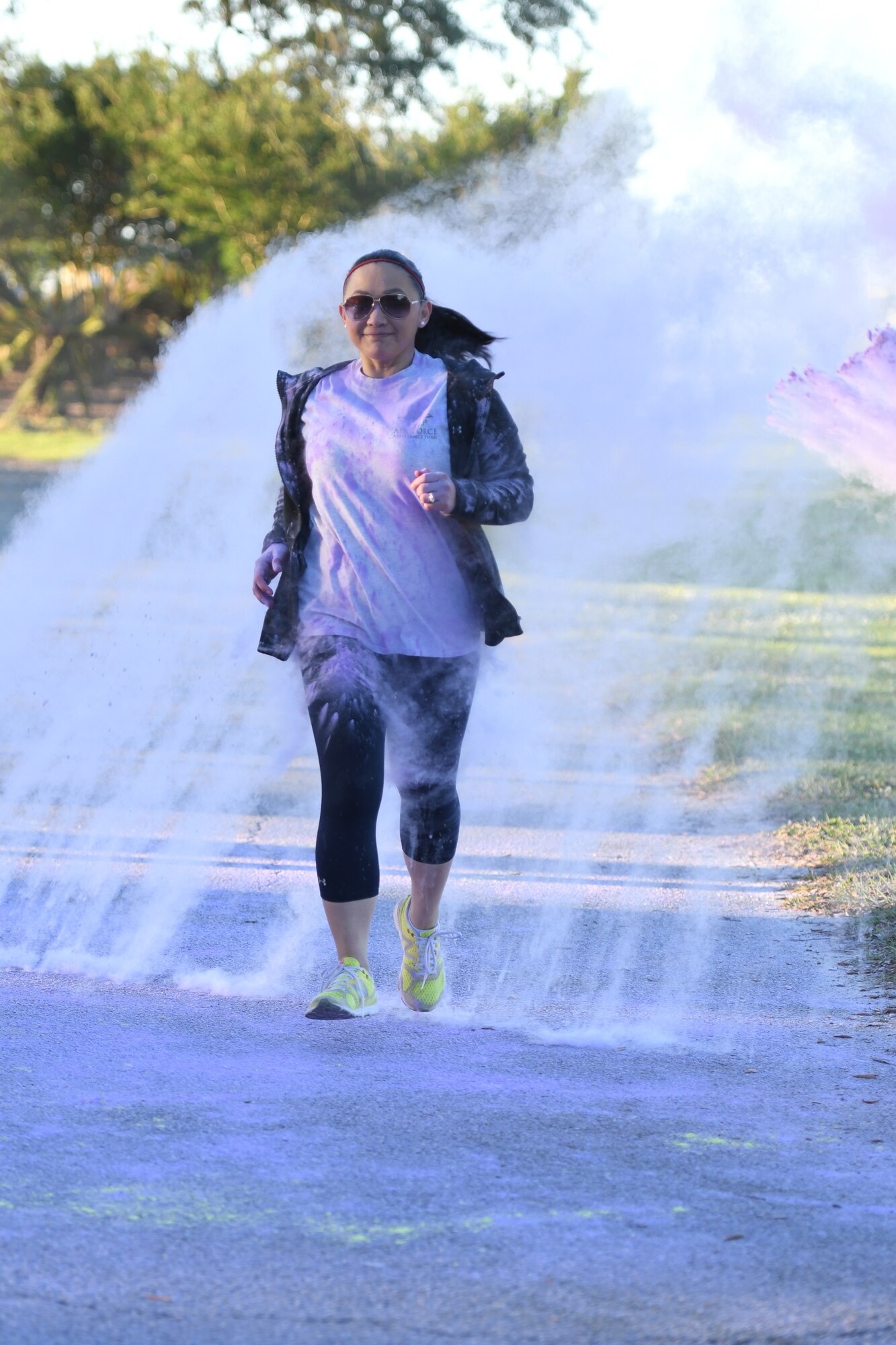 U.S. Air Force Tech. Sgt. Cecile Chatman, 81st Medical Support Squadron information systems NCO in charge, runs through purple powder during the Air Force Assistance Fund Color Run at Keesler Air Force Base, Mississippi, April 20, 2018. The AFAF raises funds for charitable affiliates that provide support to Air Force families in need. (U.S. Air Force photo by Kemberly Groue)
