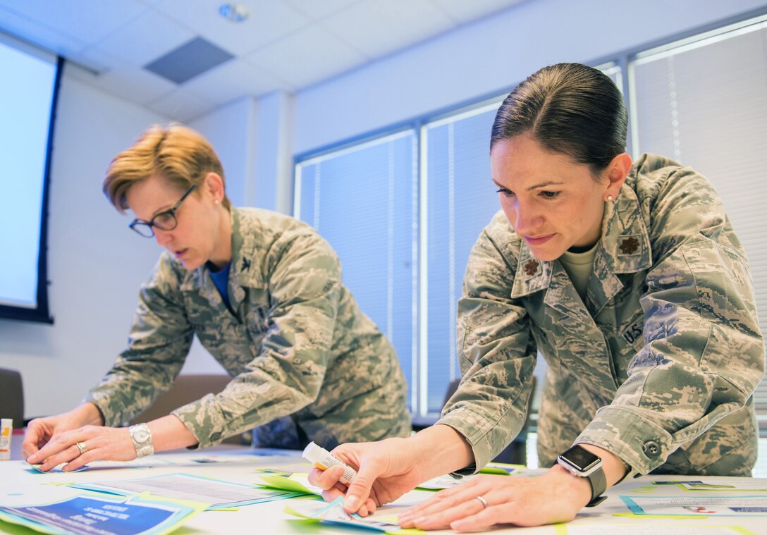 U.S. Air Force Maj. Emily Roark, right, 60th Medical Group and Col. Elizabeth Decker, Air Force Medical Service, prepare story boards for their presentation during the Transdisciplinary Evidence Based Practice Conference at NorthBay Healthcare Medical Center, Fairfield, Calif., April 13, 2018. The goal of the Transdisciplinary Evidence Based Practice Conference is to improve care based on clinical expertise, patient preference, and evidence. (U.S. Air Force photo by Louis Briscese)