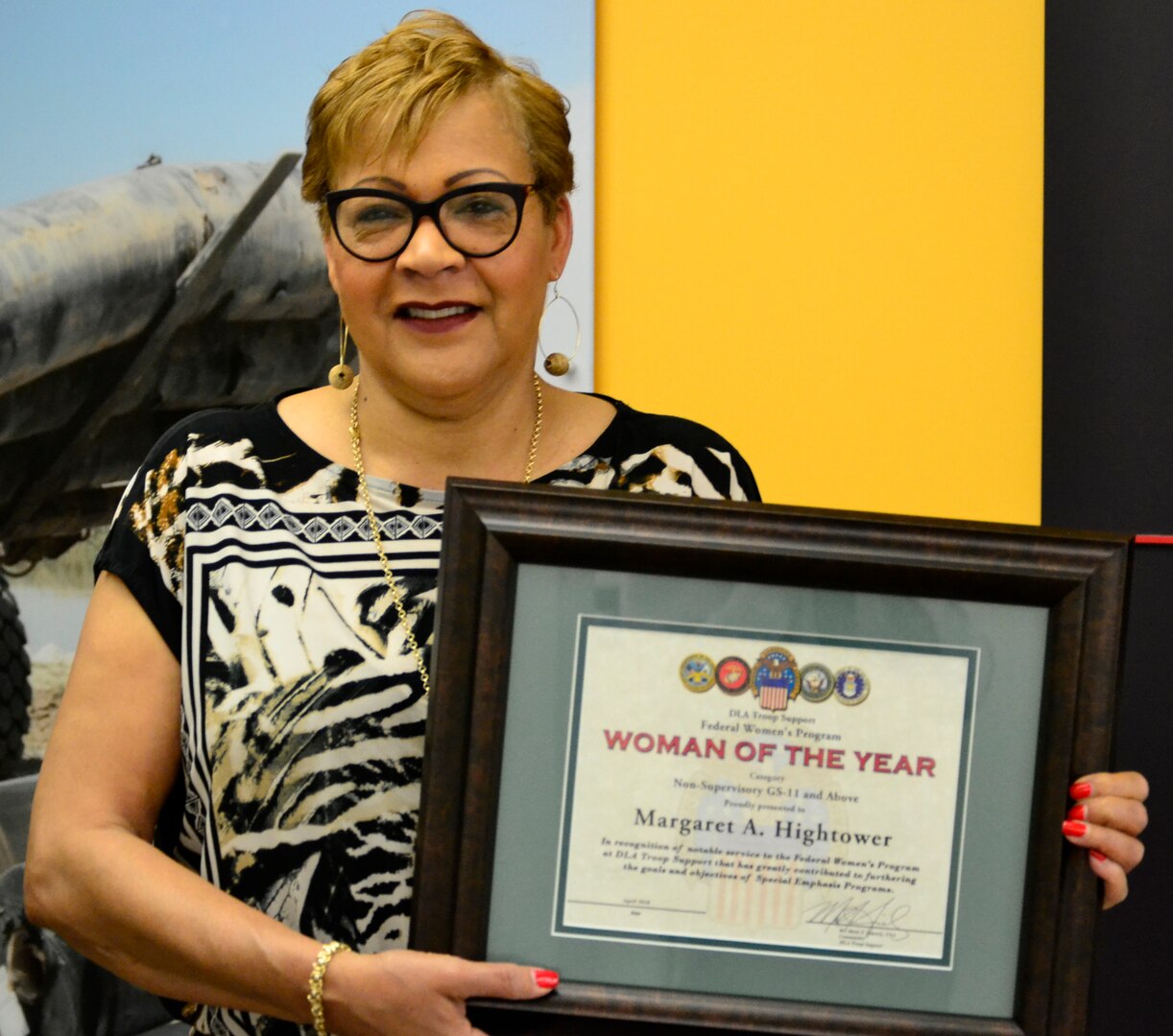 Margaret Hightower, a Construction and Equipment lead resolution specialist, poses with her award at DLA Troop Support, April 24, 2018 in Philadelphia.