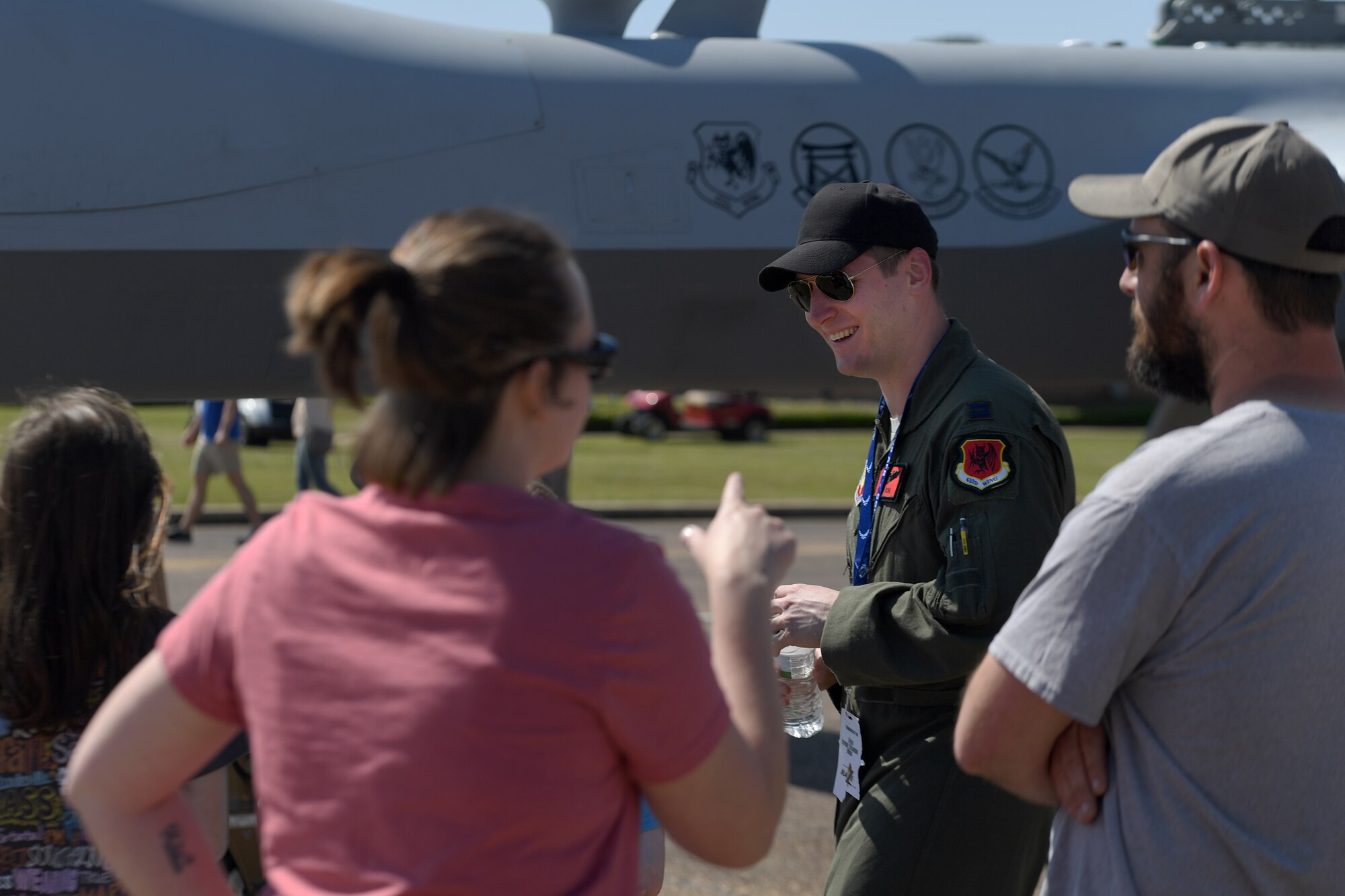 An MQ-9 Reaper pilot assigned to the 432nd Wing/432nd Air Expeditionary Wing briefs a crowd on the MQ-9 Reaper and its capabilities during the 2018 Wings over Columbus Air and Space Expo, at Columbus Air Force Base, Mississippi. Aircrew stood by the MQ-9 model and fielded RPA questions in efforts to address any misinformation attendees may have about the MQ-9 mission. (U.S. Air Force photo by Senior Airman James Thompson)