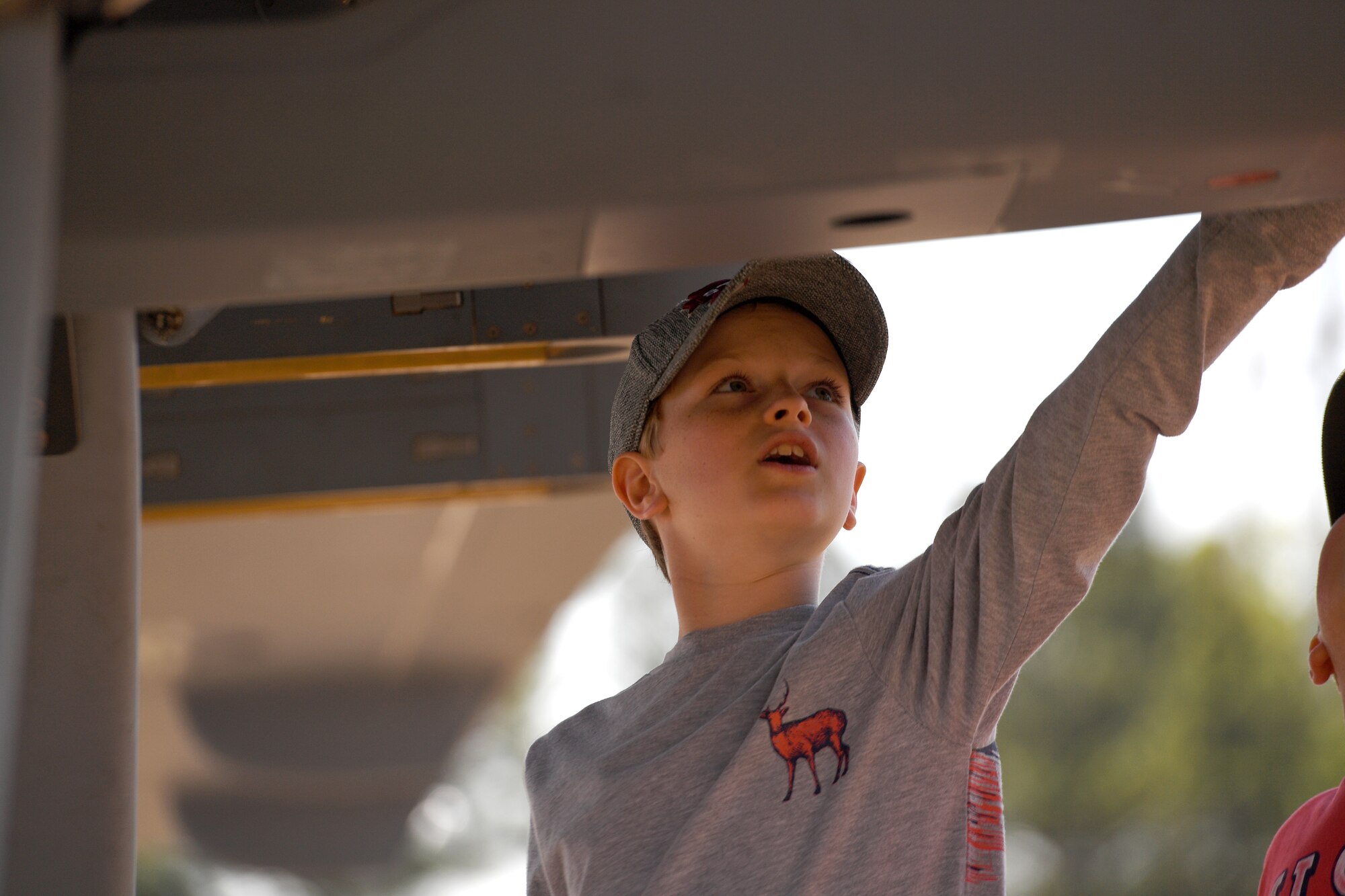 A child touches the fuselage of the MQ-9 Reaper model during the 2018 Wings over Columbus Air and Space Expo April 21, 2018, at Columbus Air Force Base, Mississippi. The model is the only one of its kind in the Air Force inventory and is used to show visitors a life-size representation of the Reaper.  (U.S. Air Force photo by Senior Airman James Thompson)