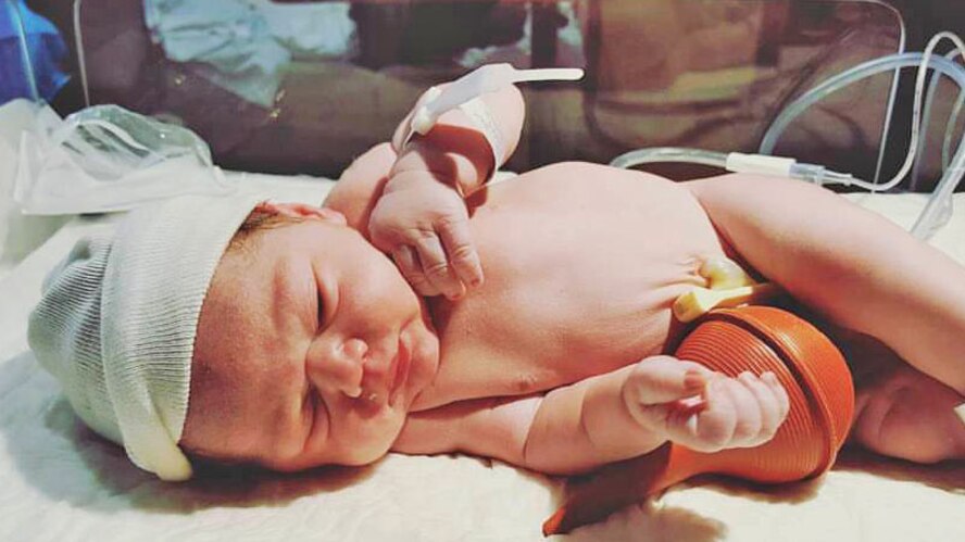 Noah Mockovciak, Team Shaw child, lies in his bed after being born at a hospital in Columbia, S.C., circa December 2016.