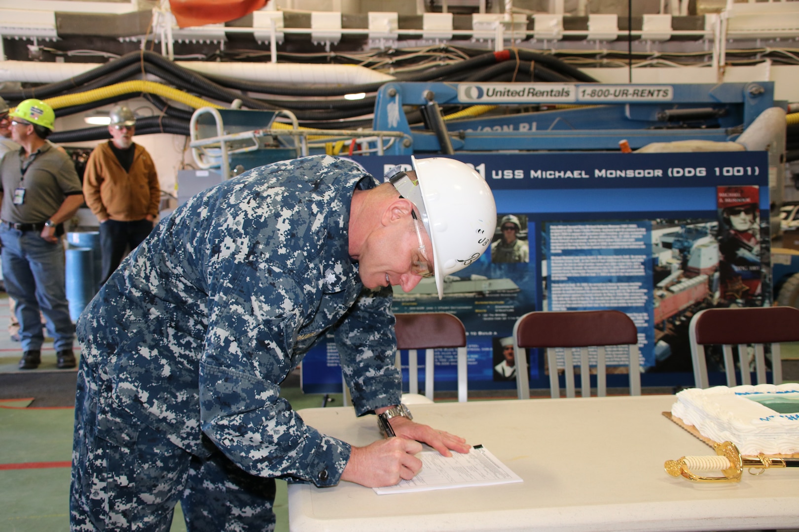 Cmdr. John Bauer, DDG 1000 program manager's representative, signs paperwork accepting delivery of the future USS Michael Monsoor (DDG 1001).  Following a crew certification period, Michael Monsoor will transit to its homeport in San Diego, California, for commissioning in January 2019.
