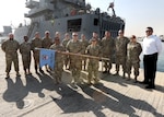 Army Lt. Col. Paul V. McCullough III (center) and Air Force Master Sgt. Romelia Jackson (second from left) stand with the DLA Support Team in a unit photo. McCullough and Jackson both deployed for six months before returning to their duties with DLA Troop Support’s Construction and Equipment supply chain.