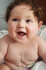 Noah Mockovciak, Team Shaw child, smiles as he sits on a bed at Charleston, S.C., circa September 2017.