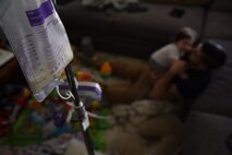 U.S. Air Force Tech. Sgt. Ben Mockovciak, 372nd Training Squadron Detachment 202 F-16 tactical aircraft maintenance instructor, plays with his son, Noah Mockovciak, as Noah is fed through a gastrostomy tube in their home at Columbia, S.C., March 15, 2018.