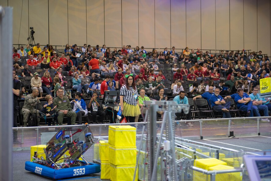 U.S. Air Force Col. Scott A. Cain (seated third from left on the front row), Arnold Engineering Development Complex commander, watches the Alliance round of the 2018 FIRST® Robotics Competition Rocket City Regional at the Von Braun Center in Huntsville, Alabama, March 17, 2018. During the Alliance round the top eight teams who placed as Alliance Team Captains during the morning’s qualifying rounds get to choose two other teams to compete with them during the final rounds for a chance at going to the FIRST® Robotics Competition World Championship in Houston, Texas in April 2018. (U.S. Air Force photo/Christopher Warner)