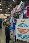 U.S. Air Force Col. Scott A. Cain, Arnold Engineering Development Complex commander, speaks with members of Team Appreciate from Austin, Texas at the 2018 FIRST® Robotics Competition Rocket City Regional at the Von Braun Center in Huntsville, Alabama, March 17, 2018. This year’s FIRST® Robotics Competition Rocket City Regional had 45 teams competing from all across the U.S. and Brazil. Each team had to design and build a competition ready robot in under six weeks. (U.S. Air Force photo/Christopher Warner)