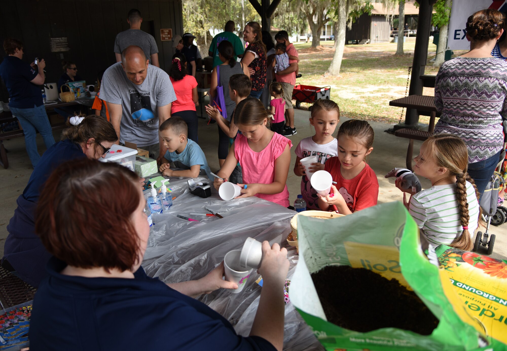 Keesler children decorate cups used for planting flower seeds during Child Pride Day at Marina Park at Keesler Air Force Base, Mississippi, April 21, 2018. Games, fun runs, pontoon boat rides and educational displays were available for military families who attended. (U.S. Air Force photo by Kemberly Groue)