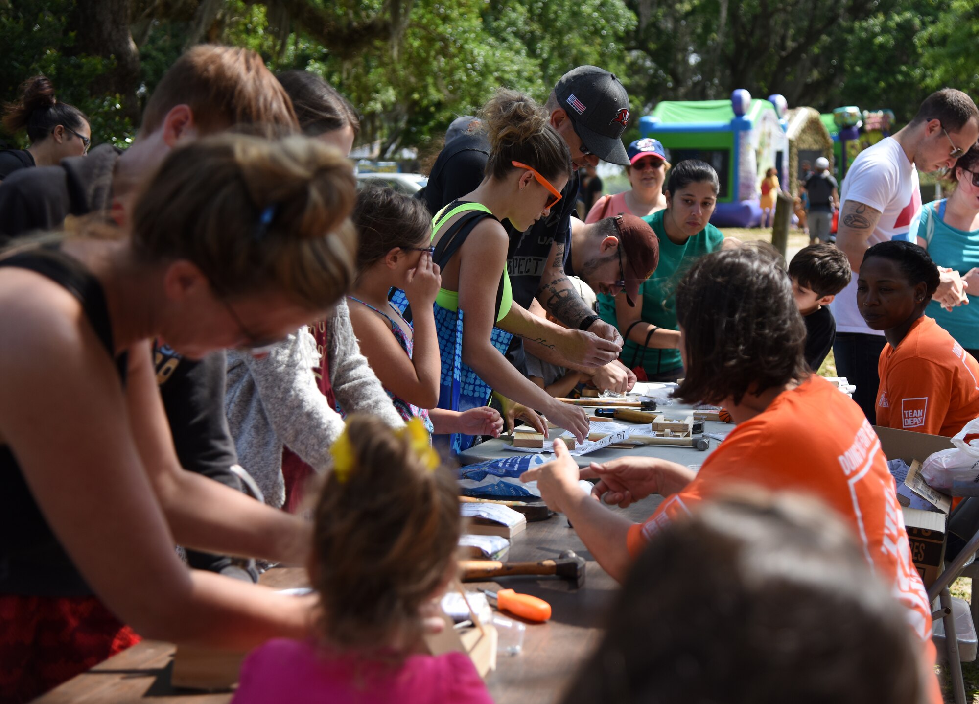 Keesler families assemble wooden crafts during Child Pride Day at Marina Park at Keesler Air Force Base, Mississippi, April 21, 2018. The 81st Force Support Squadron hosted event was held in celebration of Month of the Military Child as a time to honor the sacrifices made by military families worldwide, with an emphasis on the experience of the children of military members serving at home and overseas. Games, fun runs, pontoon boat rides and educational displays were available for military families who attended. (U.S. Air Force photo by Kemberly Groue)