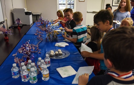 Children grab cupcakes and refreshments at the end of the Airman and Family Readiness Center’s “Little Heroes” ceremony April 18, 2018, at Joint Base Charleston, S.C.