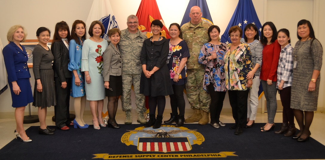 The 53rd Adjutant General of the Pennsylvania National Guard Air Force Maj. Gen. Anthony Carrelli and his senior enlisted advisor, Army Command Sergeant Major Harry Buchanan III pose with the employees of DLA Troop Support’s flag room.