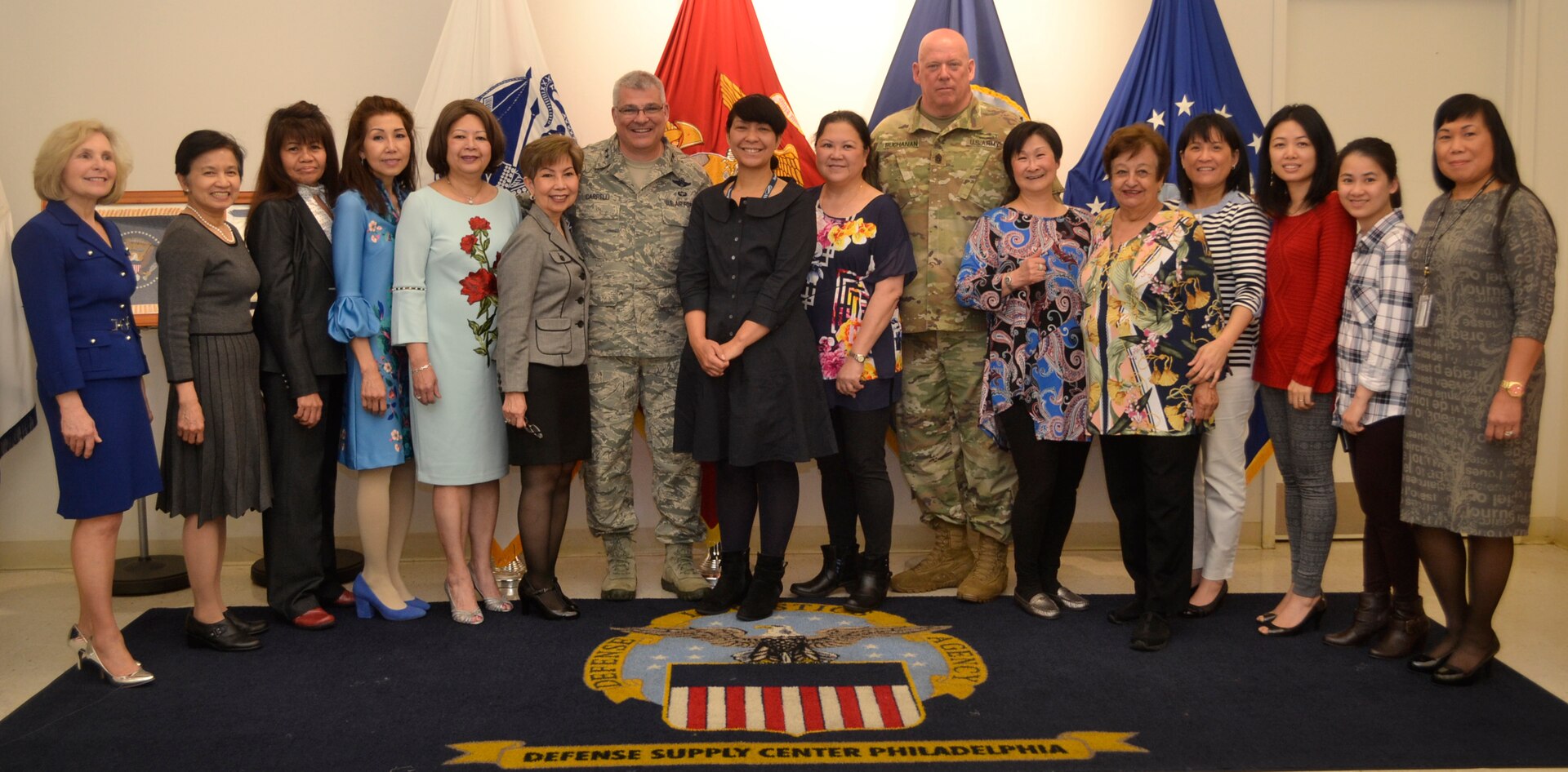 The 53rd Adjutant General of the Pennsylvania National Guard Air Force Maj. Gen. Anthony Carrelli and his senior enlisted advisor, Army Command Sergeant Major Harry Buchanan III pose with the employees of DLA Troop Support’s flag room.