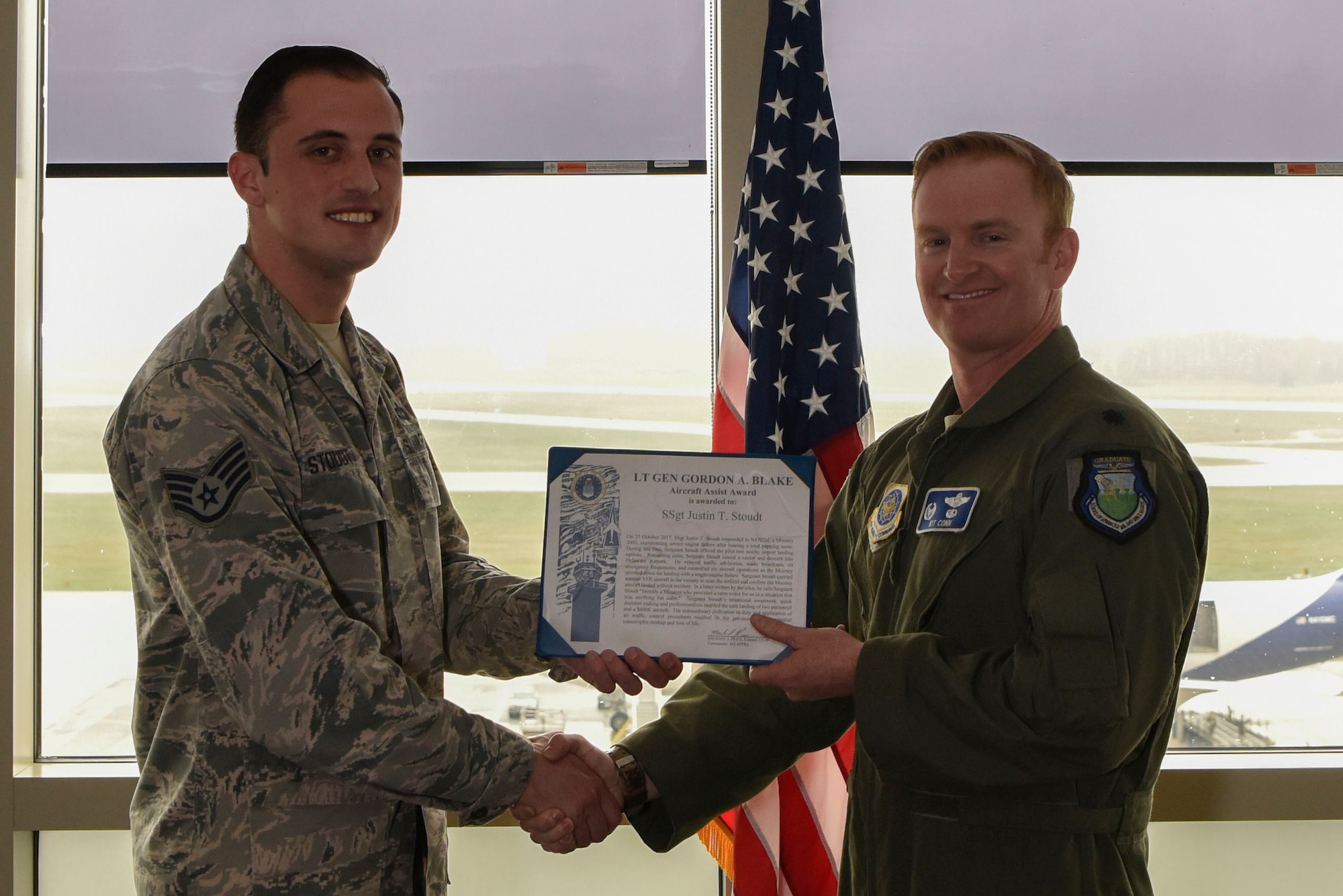 Lt. Col. Kit Conn, 436th Operations Support Squadron commander (right) presents Staff Sgt. Justin Stoudt, 436th OSS Radar Approach Control air traffic controller, with the Lt. Gen. Gordon A. Blake Aircraft Save Award April 19, 2018, at Dover Air Force Base, Del. Stoudt was presented the award for his impeccable composure and attentiveness during an emergency landing situation in October 2017. (U.S. Air Force photo by Airman 1st Class Zoe M. Wockenfuss)