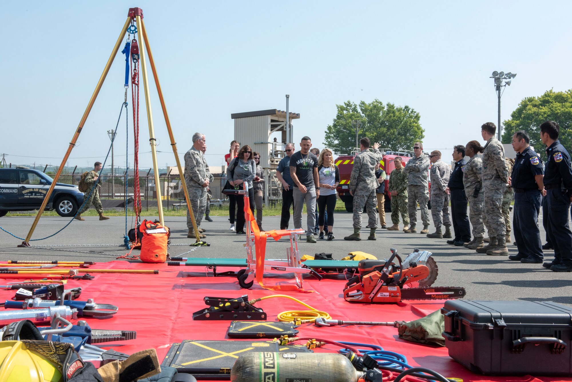 Members of the 374th Civil Engineer Squadron prepare to showcase their life-saving equipment with USO Spring Tour performers and UFC fighters Paige VanZant and Max Holloway at Yokota Air Base, Japan, April 22, 2018.