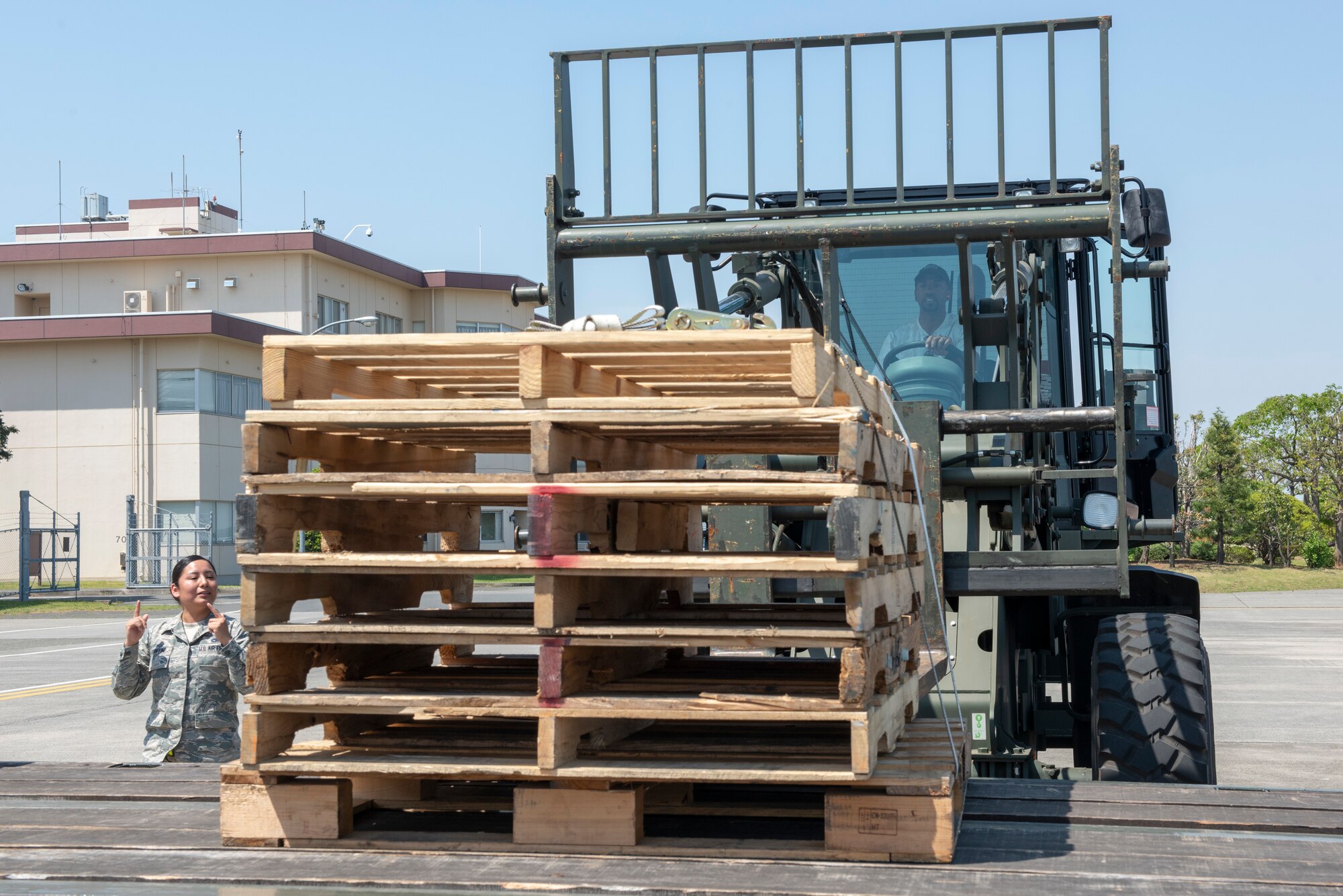 Richard “Rip” Hamilton, retired NBA player, navigates a piece of heavy equipment into position to lift a set of pallets during the vehicle rodeo portion of the USO Spring Tour at Yokota Air Base, Japan, April 22, 2018.
