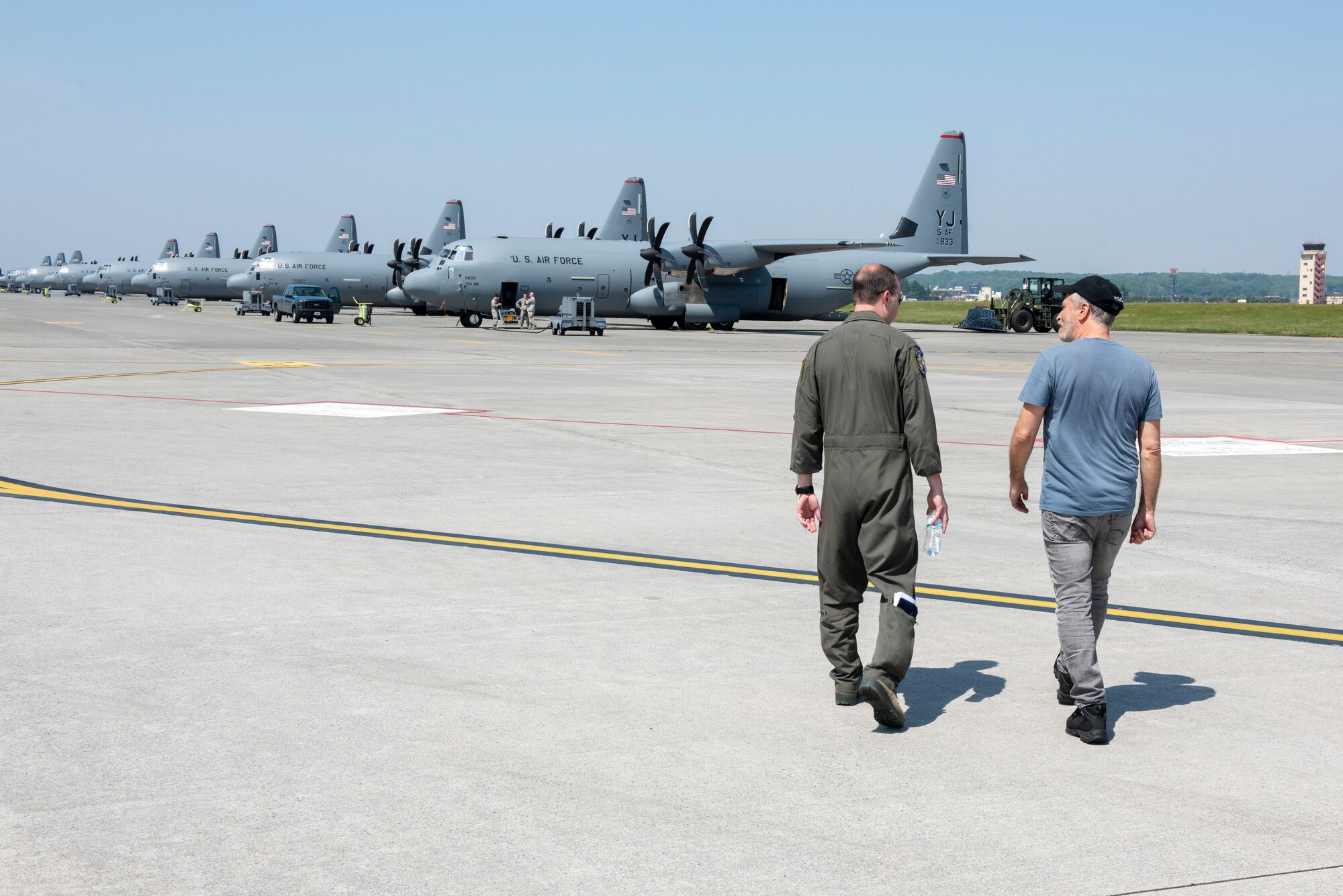 Jon Stewart, comedian, converses with an Airman from the 374th Airlift Wing prior to a C-130J Super Hercules static tour during the USO Spring Tour at Yokota Air base, Japan, April 22, 2018.