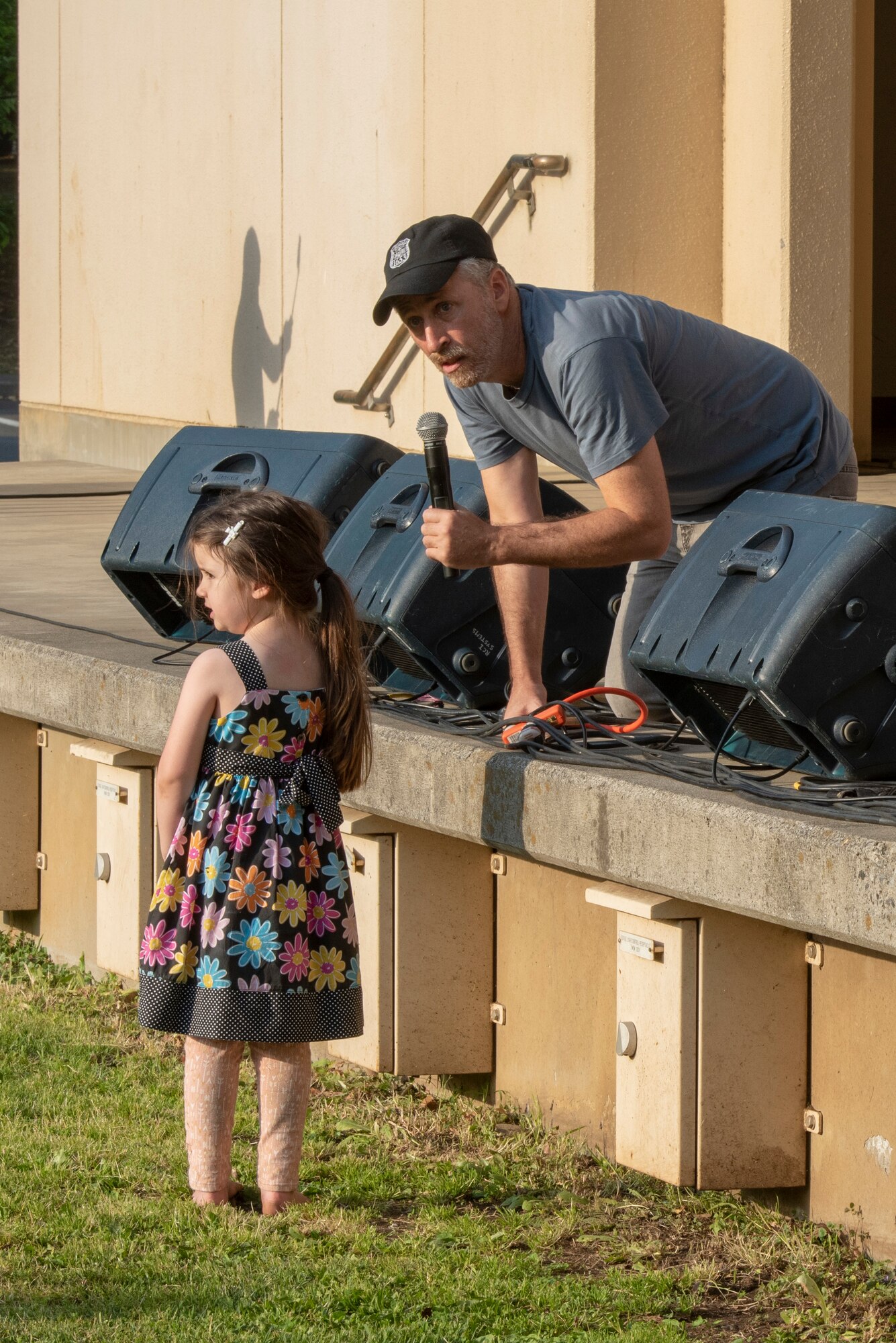 Jon Stewart, famous comedian, writer, producer and director, interacts with a small child from the audience during the USO Spring Tour at Yokota Air Base, Japan, April 22, 2018.