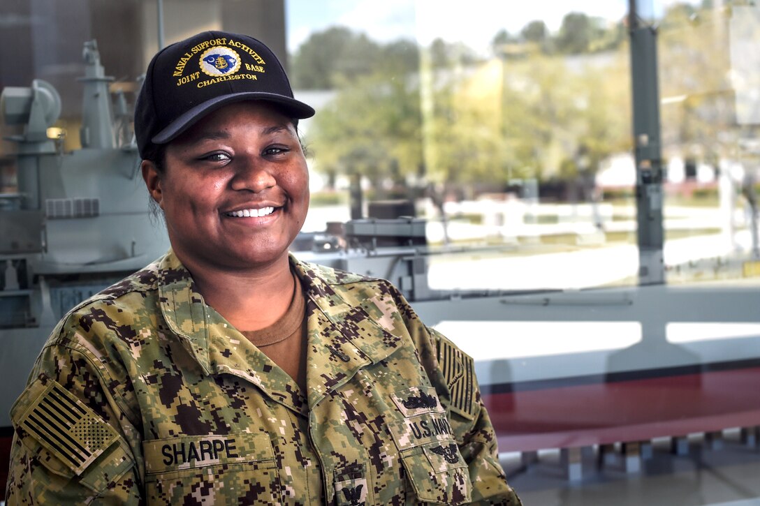 A female Navy petty officer poses for a photo.