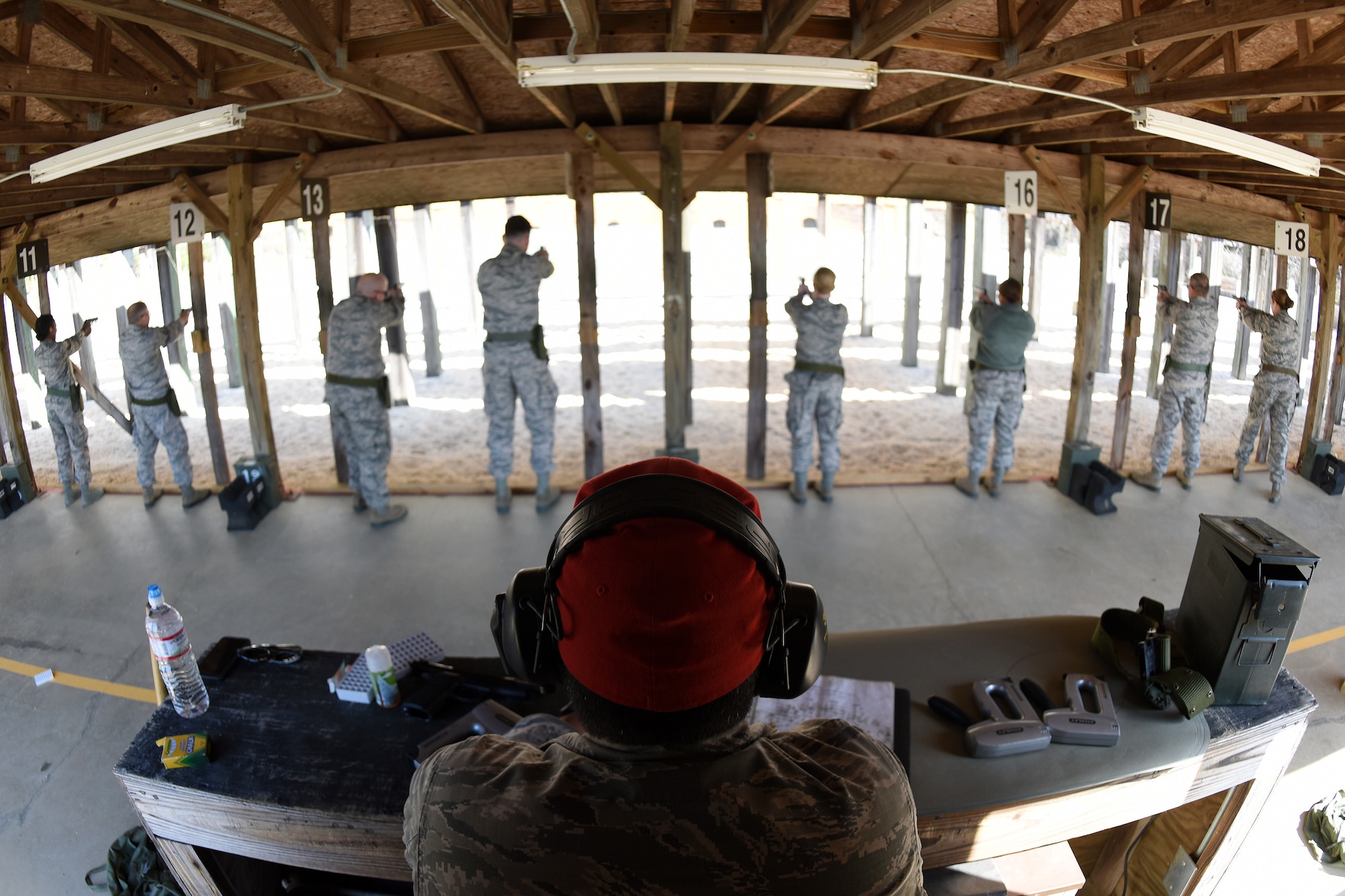 U.S. Air Force Staff Sgt. Andre Buck, a Combat Arms Training and Maintenance instructor with the 169th Security Forces Squadron at McEntire Joint National Guard Base, South Carolina Air National Guard, gives instructions during M-9 pistol qualifications at the base shooting range, April 6, 2018. Swamp Fox Airmen continue to hone routine skills to meet combatant command requirements. The muscle memory that is formed by using this equipment multiple times allows Airmen the ability to focus their attention on completing the mission under austere conditions. (U.S. Air National Guard photo by Master Sgt. Caycee Watson)