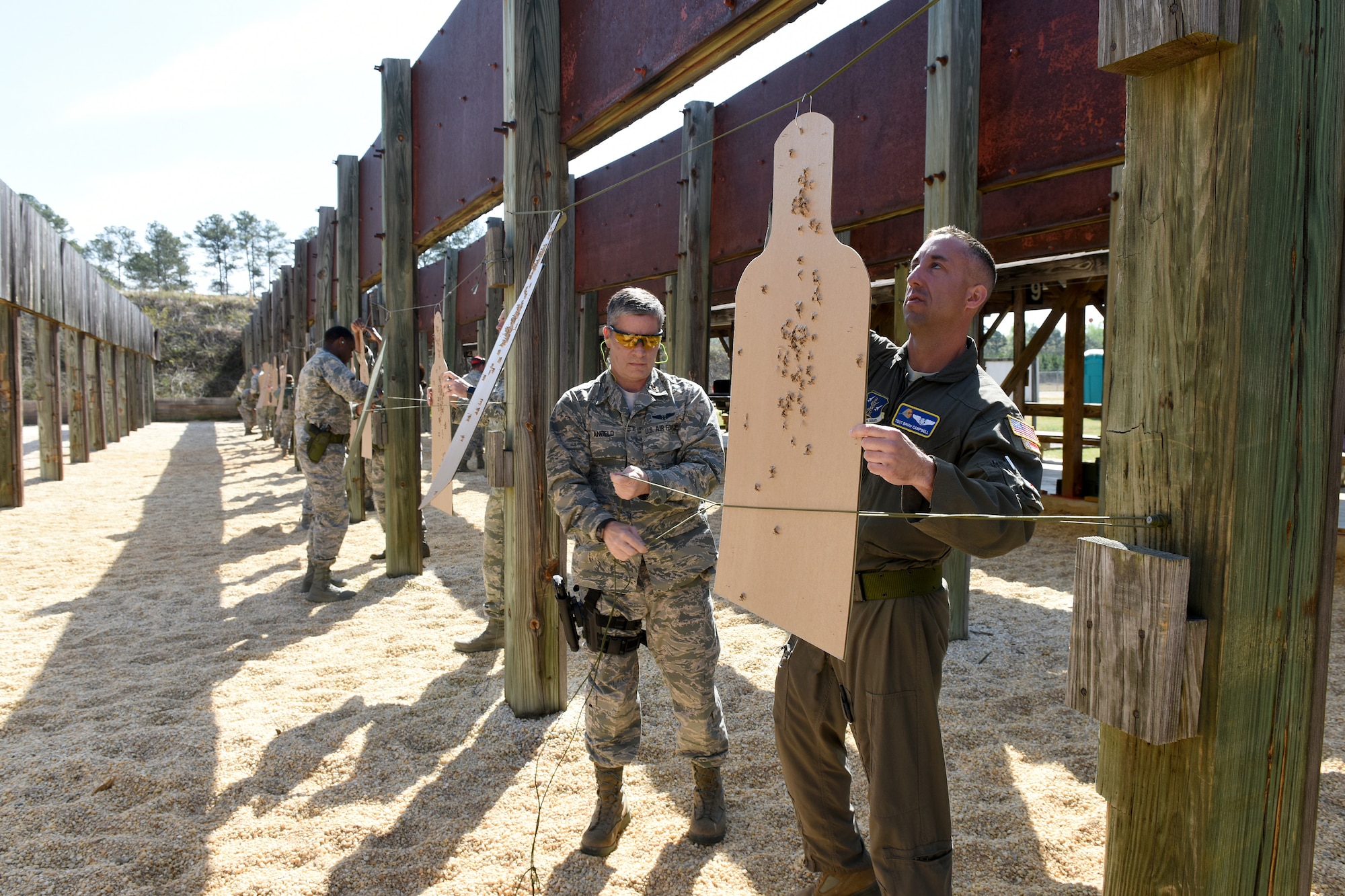 U.S. Airmen with the 156th Aeromedical Evacuation Squadron, North Carolina Air National Guard, participate in M-9 pistol training at McEntire Joint National Guard Base shooting range with South Carolina Air National Guard Combat Arms Training and Maintenance instructors from the 169th Security Forces Squadron, April 6, 2018. Swamp Fox Airmen continue to hone routine skills to meet combatant command requirements. The muscle memory that is formed by using this equipment multiple times allows Airmen the ability to focus their attention on completing the mission under austere 
conditions. (U.S. Air National Guard photo by Master Sgt. Caycee Watson)