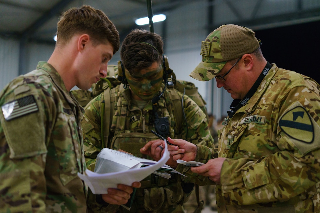 Soldiers discuss operations plans.