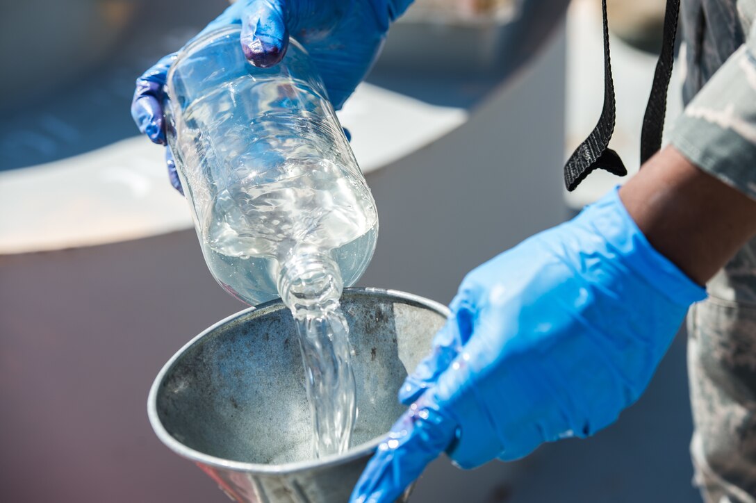 An Airmen  from the 733rd Logistics Readiness Squadron fuel laboratory pours fuel into a bottle at Joint Base Langley-Eustis, Virginia, March 23, 2018. The laboratory technicians bring their samples back to their lab to run various tests on the fuel. (U.S. Air Force photo by Airman 1st Class Tristan Biese)