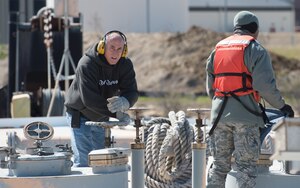 Jeff Jenkins, barge captain, opens a fuel tank so that the Airmen from 733rd Logistics Readiness Squadron fuel laboratory can run tests, at Joint Base Langley-Eustis, Virginia, March 23, 2018. The LRS Airmen must test the fuel to check if it contains any water before they can begin pumping. (U.S. Air Force photo by Airman 1st Class Tristan Biese)