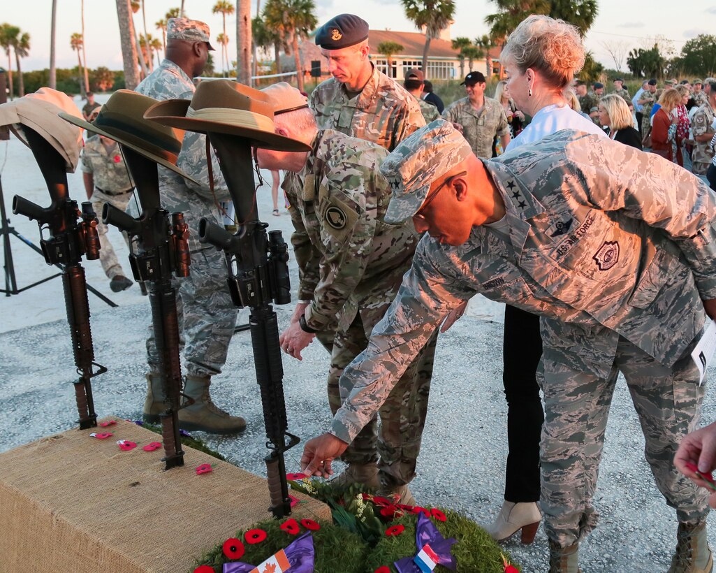 U.S. Air Force Lt. Gen Charles Q. Brown Jr., deputy commander, U.S. Central Command, places a red poppy on an Anzac Day memorial during a dawn service on the beach at MacDill Air Force Base, April 25. The red, or Flanders, poppy has become a universal symbol of war remembrance since World War I when Lt. Col. John McCrae, a Canadian medical officer, noticing the plant blooming in a cemetery, penned ‘In Flanders Fields.’  

Personnel and family members from U.S. Central Command, U.S. Special Operations Command, and MacDill AFB attended the commemoration service that marks the anniversary of the military campaign on the Gallipoli Peninsula fought by Australian and New Zealand forces during World War I.  Anzac Day also commemorates the lives lost by Australians and New Zealanders during World War II and subsequent military and peacekeeping operations. (Photo by Tom Gagnier)