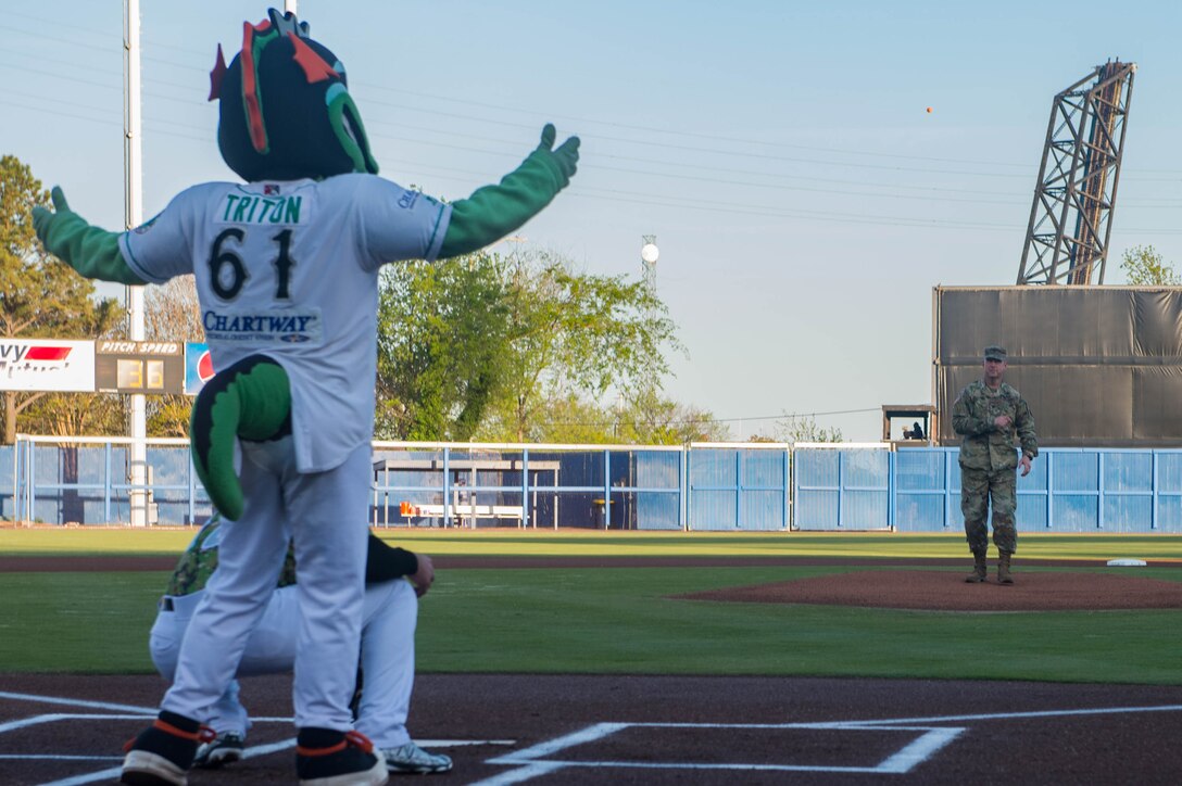 (Right) U.S. Army Col. Ralph Clayton, 733rd Mission Support Group commander, throws the first pitch at a Norfolk Tides game at Harbor Park, Virginia, April 21, 2018. Fort Eustis, Virginia is celebrating its 100 years and remembering the variety of missions it has supported since 1918. (U.S. Air Force photo by Senior Airman Derek Seifert)