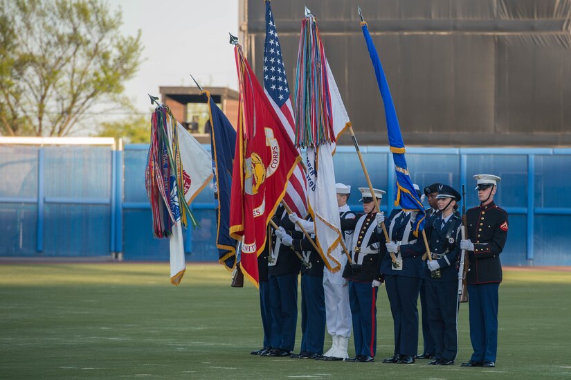 The Joint Service Color Guard presents the American Flag and the five U.S. military branch flags during the National Anthem during a Norfolk Tides game at Harbor Park, Virginia, April 21, 2018. Fort Eustis, Virginia is celebrating its 100 years and remembering the variety of missions it has supported since 1918. (U.S. Air Force photo by Senior Airman Derek Seifert)