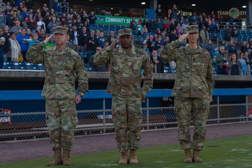 U.S. Army Fort Eustis leadership salutes during the national anthem at a Norfolk Tides game at Harbor Park, Virginia, April 21, 2018. Fort Eustis, Virginia is celebrating its 100 years and remembering the variety of missions it has supported since 1918. (U.S. Air Force photo by Senior Airman Derek Seifert)