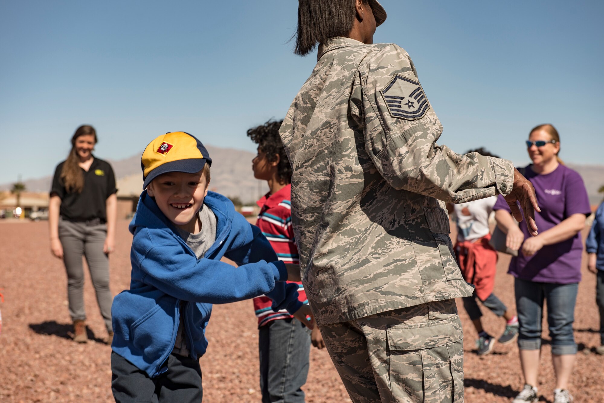 A child tags an Airman during a Leave No Trace workshop at Nellis Air Force Base, Nevada, March 28, 2018. The game simulated how invasive species can have a negative impact on the environment. (U.S. Air Force photo by Airman 1st Class Andrew D. Sarver)