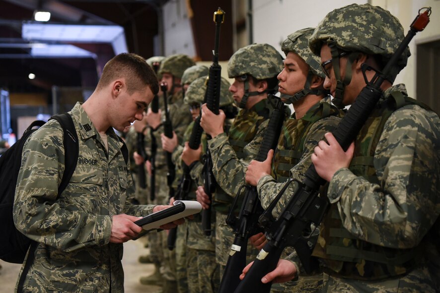 Cadet Maj. Avery Buggert, a member of the ROTC program at the University of North Dakota, inspects Airmen on Grand Forks Air Force Base, N.D., April 21, 2018. Buggert verified all Airmen had the correct weaponry and equipment to ensure they were prepared for a readiness exercise. (U.S. Air Force photo by Airman 1st Class Melody Wolff)